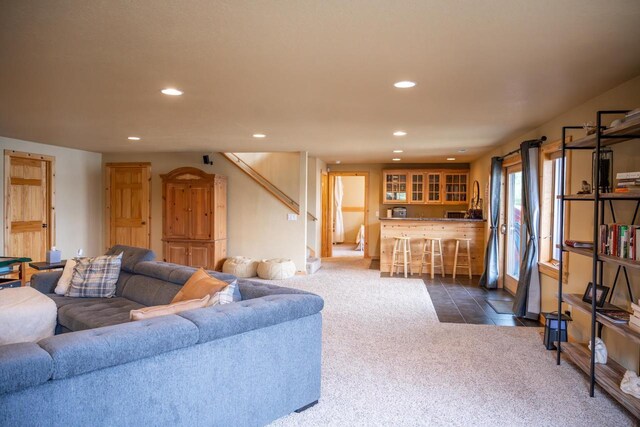 W5588 S Stone Gate Dr, New Lisbon, WI 53950 - living area with recessed lighting, bar, stairway, and dark colored carpet