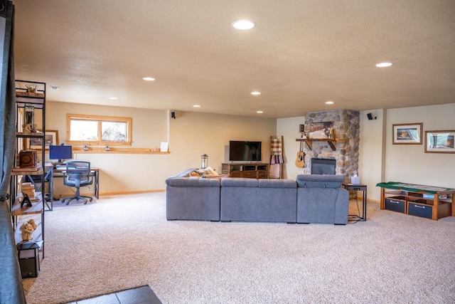 W5588 S Stone Gate Dr, New Lisbon, WI 53950 - carpeted living room featuring recessed lighting, a textured ceiling, baseboards, and a stone fireplace