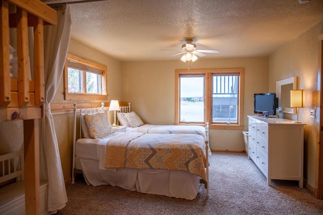 W5588 S Stone Gate Dr, New Lisbon, WI 53950 - bedroom with a ceiling fan, a textured ceiling, and light carpet