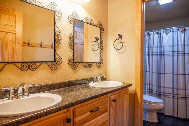 W5588 S Stone Gate Dr, New Lisbon, WI 53950 - full bathroom with a sink, a textured wall, toilet, and double vanity