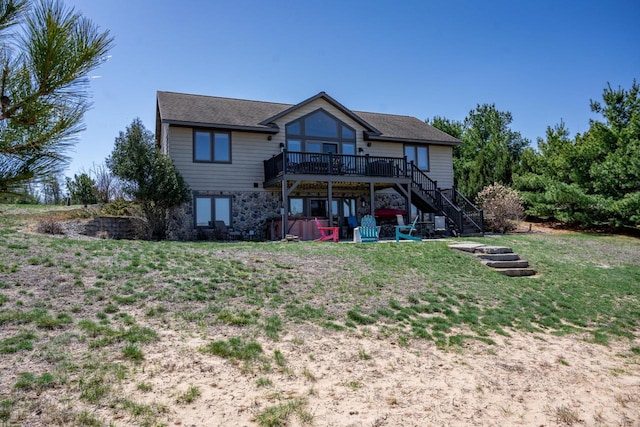 W5588 S Stone Gate Dr, New Lisbon, WI 53950 - rear view of property featuring stairway, a lawn, and a wooden deck
