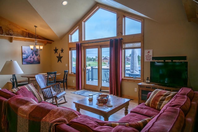 W5588 S Stone Gate Dr, New Lisbon, WI 53950 - living room with light wood-type flooring, baseboards, a notable chandelier, and vaulted ceiling