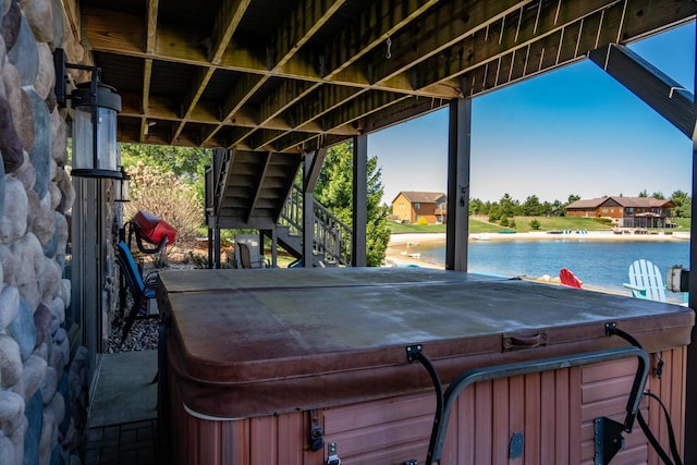 W5588 S Stone Gate Dr, New Lisbon, WI 53950 - view of patio featuring stairs, a water view, and a hot tub