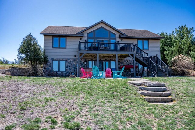 W5588 S Stone Gate Dr, New Lisbon, WI 53950 - back of house with stairs, stone siding, a yard, and a deck