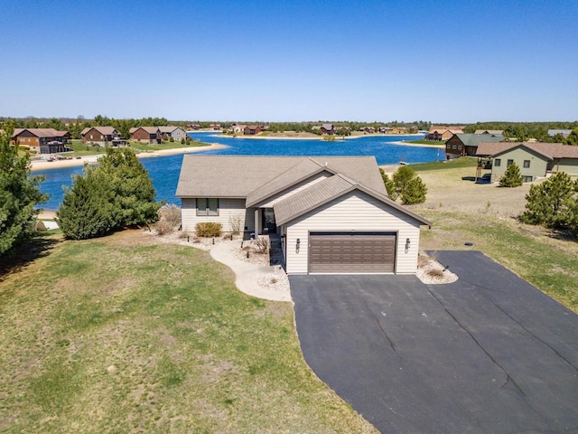 W5588 S Stone Gate Dr, New Lisbon, WI 53950 - view of front facade with a residential view, a garage, a front yard, a water view, and driveway