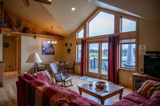 W5588 S Stone Gate Dr, New Lisbon, WI 53950 - living room with light wood finished floors, ceiling fan with notable chandelier, recessed lighting, baseboards, and lofted ceiling
