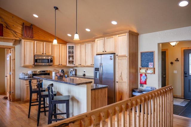 W5588 S Stone Gate Dr, New Lisbon, WI 53950 - kitchen featuring glass insert cabinets, a center island, recessed lighting, vaulted ceiling, and stainless steel appliances