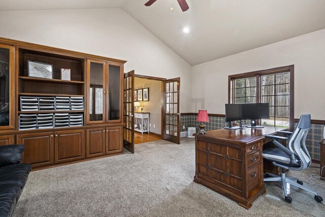 office space featuring carpet floors, high vaulted ceiling, french doors, a wainscoted wall, and a ceiling fan
