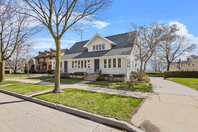 812 Milwaukee St, Kewaunee, WI 54216 - view of front of house with a shingled roof and a front lawn
