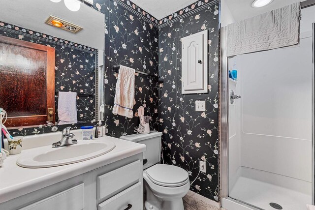 812 Milwaukee St, Kewaunee, WI 54216 - full bath with vanity, toilet, wallpapered walls, and a stall shower