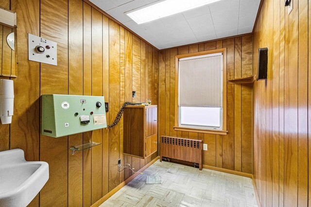 812 Milwaukee St, Kewaunee, WI 54216 - interior space with a sink, radiator heating unit, wooden walls, and tile patterned floors