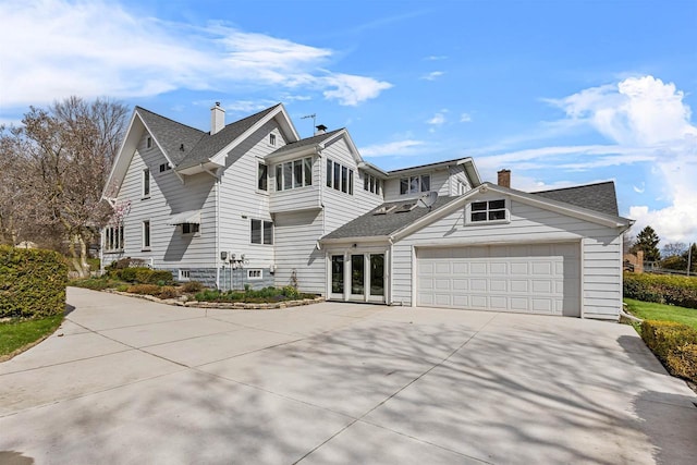 812 Milwaukee St, Kewaunee, WI 54216 - view of front of property with a shingled roof, a chimney, an attached garage, and driveway