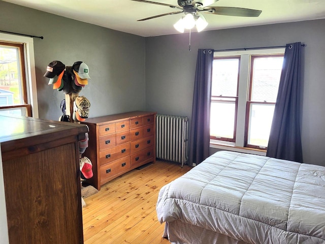 218 7th Ave, New Glarus, WI 53574 - bedroom featuring a ceiling fan, light wood finished floors, and radiator heating unit