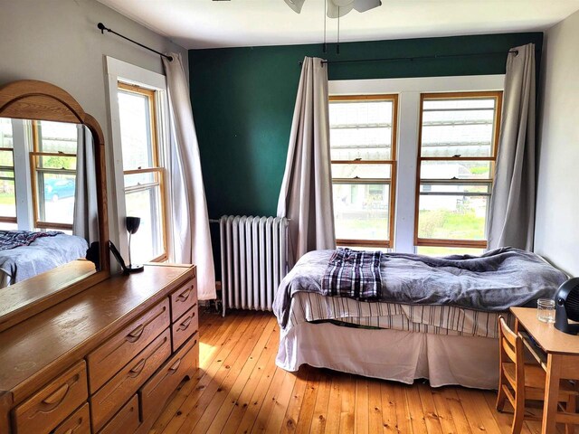 218 7th Ave, New Glarus, WI 53574 - bedroom with radiator heating unit and light wood-style flooring