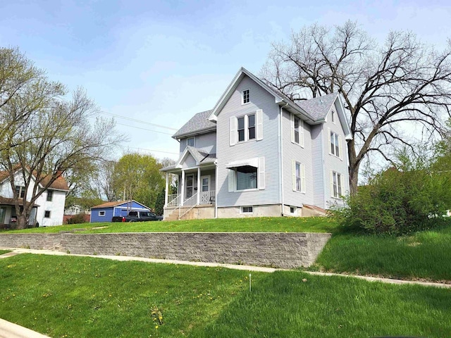 218 7th Ave, New Glarus, WI 53574 - view of front of property with covered porch and a front yard