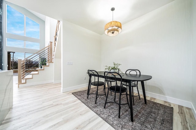 1810 White Dove Ln, Kaukauna, WI 54130 - dining space with baseboards, stairs, and wood finished floors