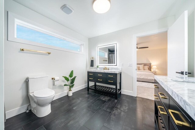 1810 White Dove Ln, Kaukauna, WI 54130 - ensuite bathroom featuring toilet, baseboards, ensuite bathroom, and vanity