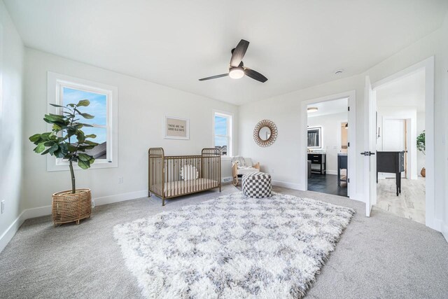 1810 White Dove Ln, Kaukauna, WI 54130 - bedroom featuring baseboards, carpet flooring, a crib, and a ceiling fan