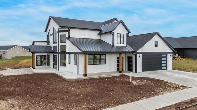 1810 White Dove Ln, Kaukauna, WI 54130 - view of front of home with an attached garage, a shingled roof, concrete driveway, a standing seam roof, and metal roof