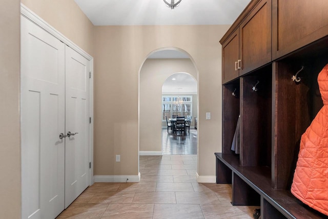 1881 Deer Trail Ct, Luxemburg, WI 54217 - mudroom with light tile patterned floors, arched walkways, and baseboards