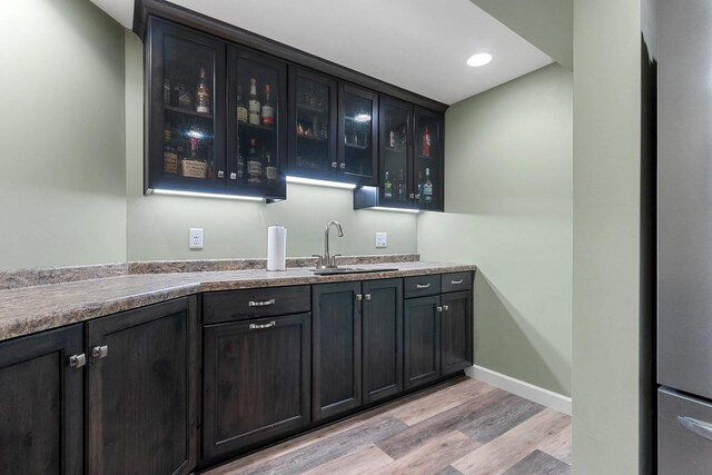 1881 Deer Trail Ct, Luxemburg, WI 54217 - bar featuring a sink, light wood finished floors, recessed lighting, baseboards, and wet bar