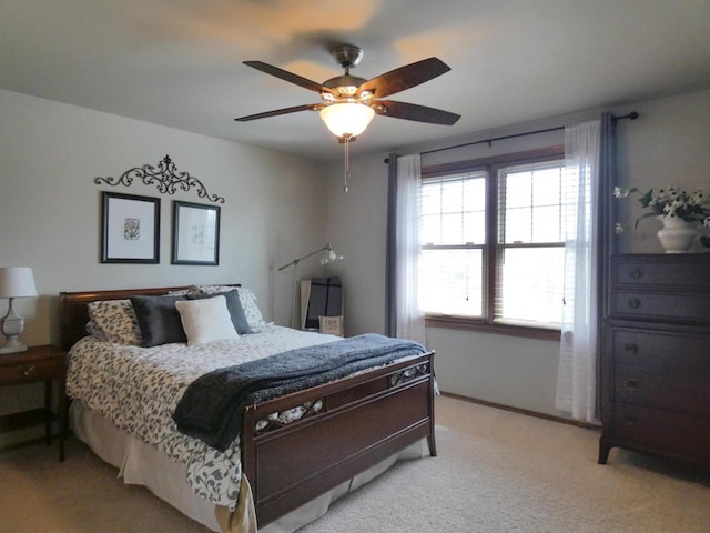 bedroom with light colored carpet, a ceiling fan, and baseboards