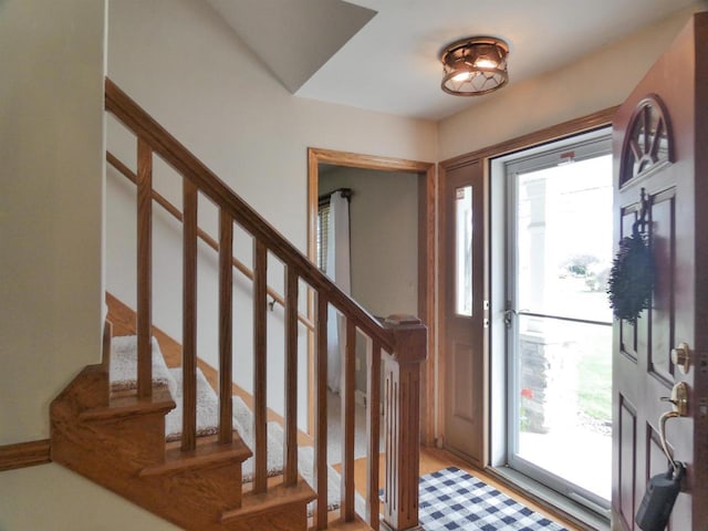 foyer featuring a healthy amount of sunlight and stairs