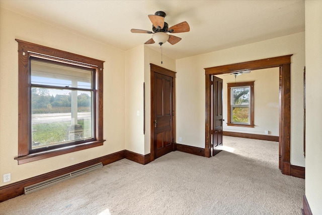 spare room featuring carpet floors, baseboards, and ceiling fan