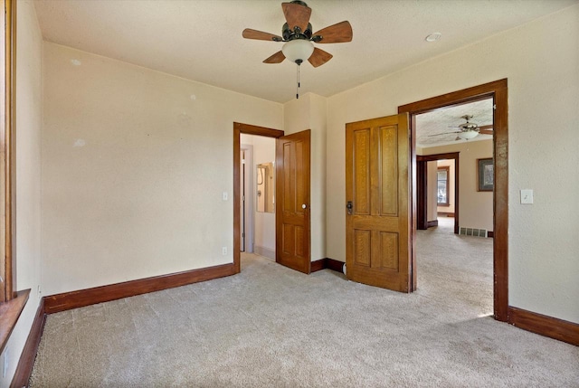 unfurnished bedroom featuring baseboards, ceiling fan, and carpet flooring