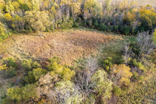 birds eye view of property featuring a view of trees
