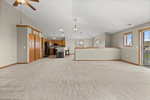 unfurnished living room with baseboards, visible vents, light colored carpet, and lofted ceiling