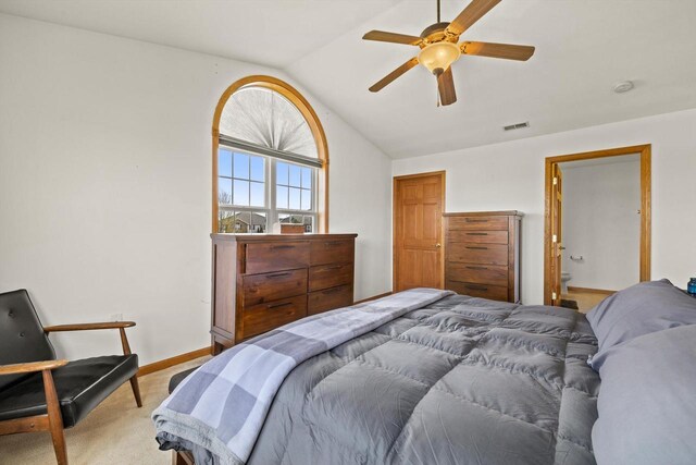 bedroom featuring visible vents, lofted ceiling, baseboards, ceiling fan, and light colored carpet