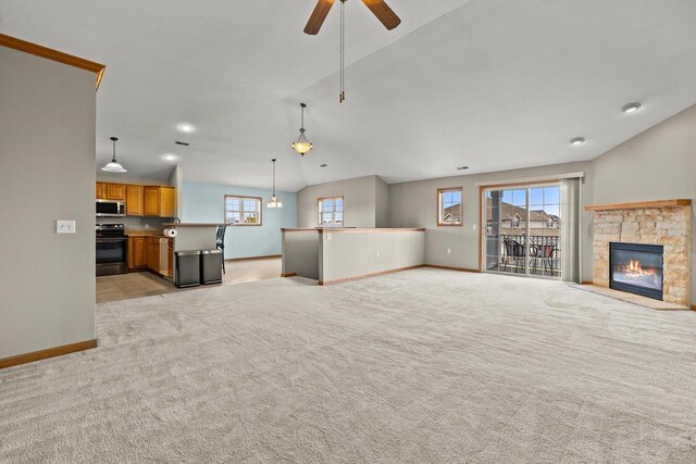 unfurnished living room with baseboards, a stone fireplace, recessed lighting, light colored carpet, and a ceiling fan