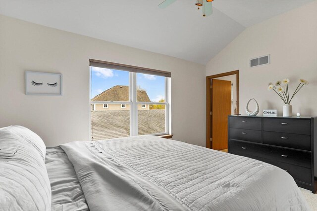 bedroom featuring a ceiling fan, vaulted ceiling, carpet flooring, and visible vents