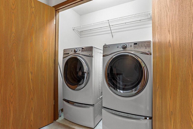 clothes washing area with laundry area and washer and clothes dryer