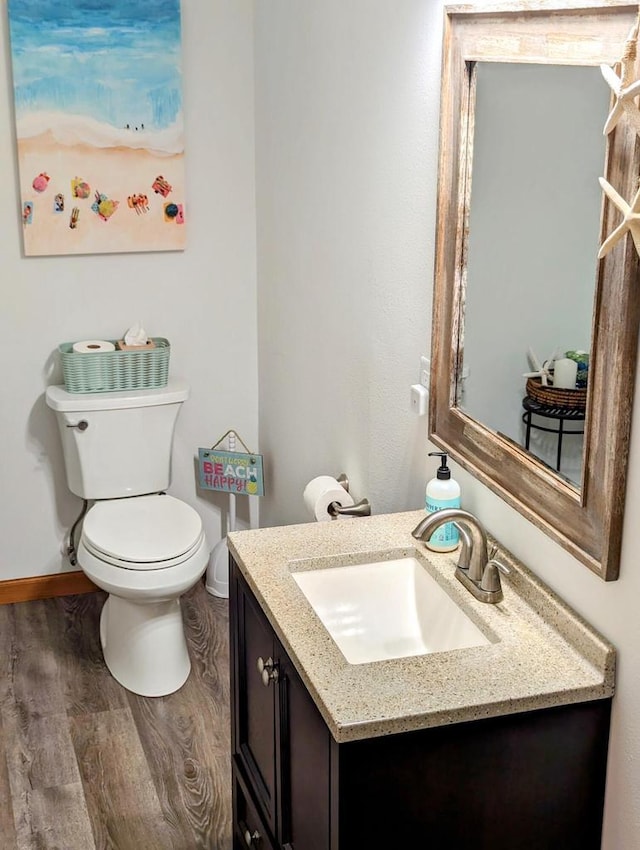 835 Mockingbird Ln, Plymouth, WI 53073 - half bathroom with vanity, wood finished floors, toilet, and baseboards