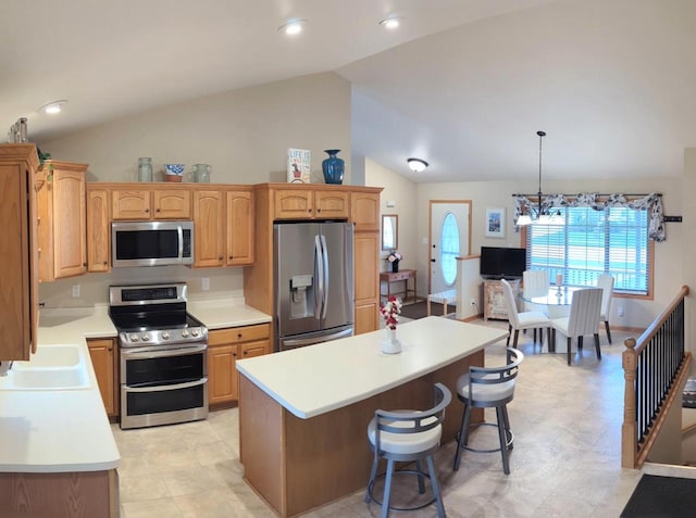 835 Mockingbird Ln, Plymouth, WI 53073 - kitchen featuring stainless steel appliances, vaulted ceiling, a sink, light countertops, and a center island