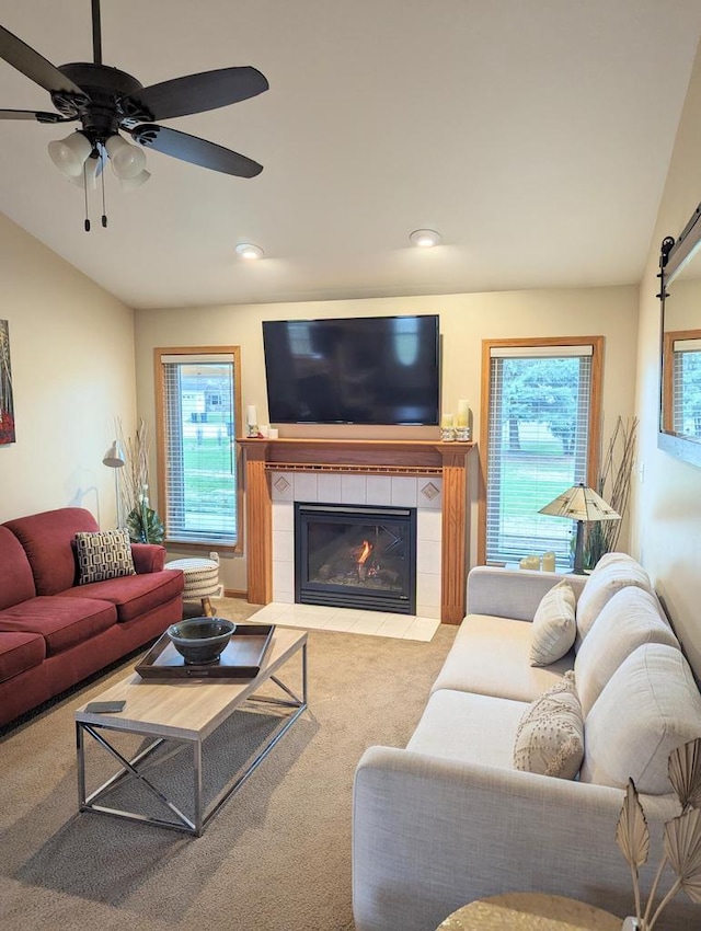 835 Mockingbird Ln, Plymouth, WI 53073 - carpeted living room featuring a fireplace, plenty of natural light, ceiling fan, vaulted ceiling, and recessed lighting