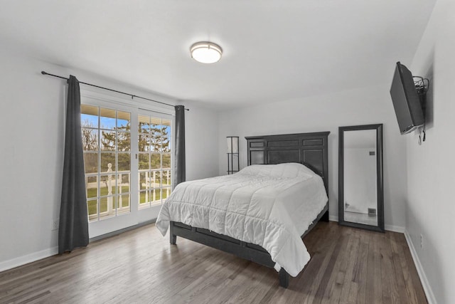 bedroom with baseboards and wood finished floors