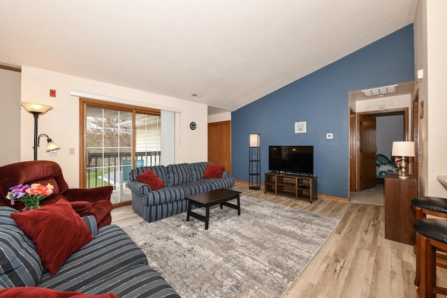 living area featuring light wood-style floors, high vaulted ceiling, baseboards, and visible vents