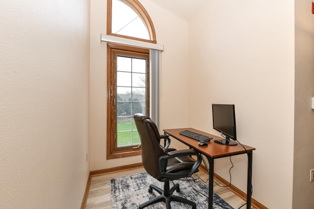 office area featuring light wood-style floors and baseboards