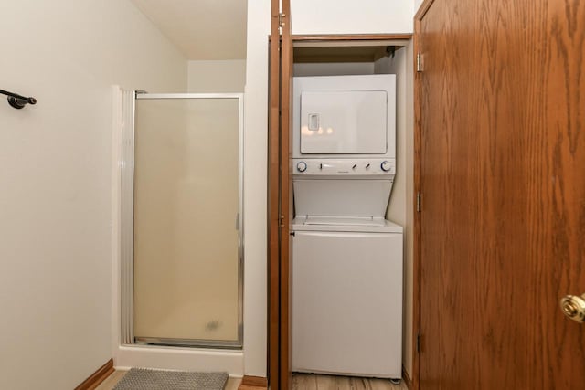 clothes washing area featuring laundry area and stacked washer and dryer