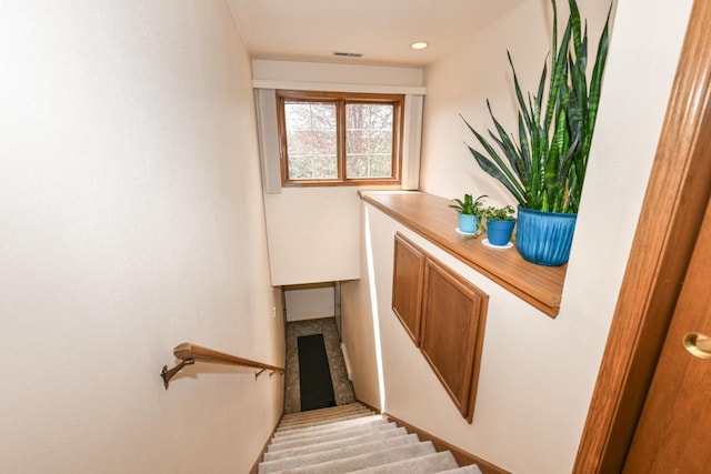 staircase featuring visible vents
