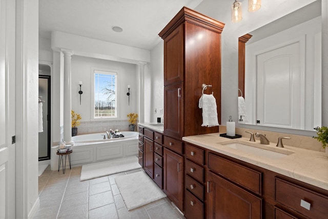 bathroom featuring vanity, a garden tub, decorative columns, tile patterned flooring, and a stall shower