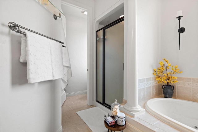 full bath featuring tile patterned floors, a bath, and a stall shower