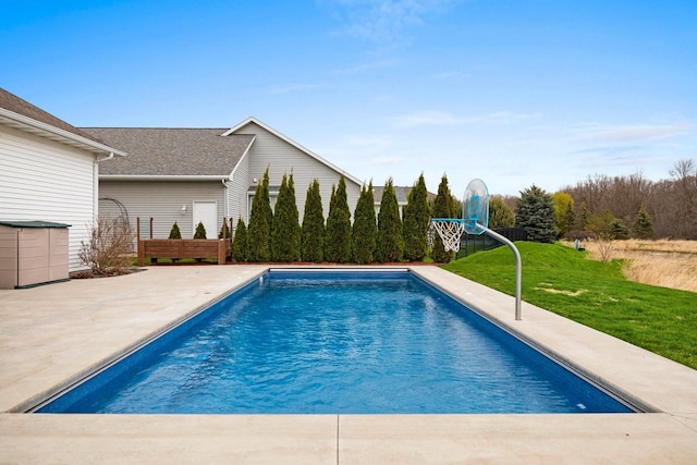 outdoor pool featuring a patio and a yard