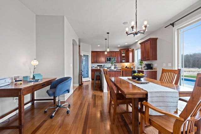 dining space with recessed lighting, baseboards, an inviting chandelier, and dark wood-type flooring