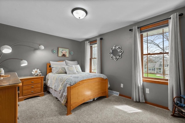 carpeted bedroom with visible vents and baseboards