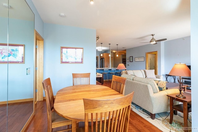 dining room featuring a ceiling fan and wood finished floors