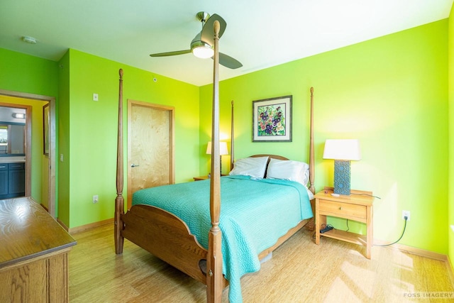 bedroom featuring baseboards, ceiling fan, and light wood-type flooring